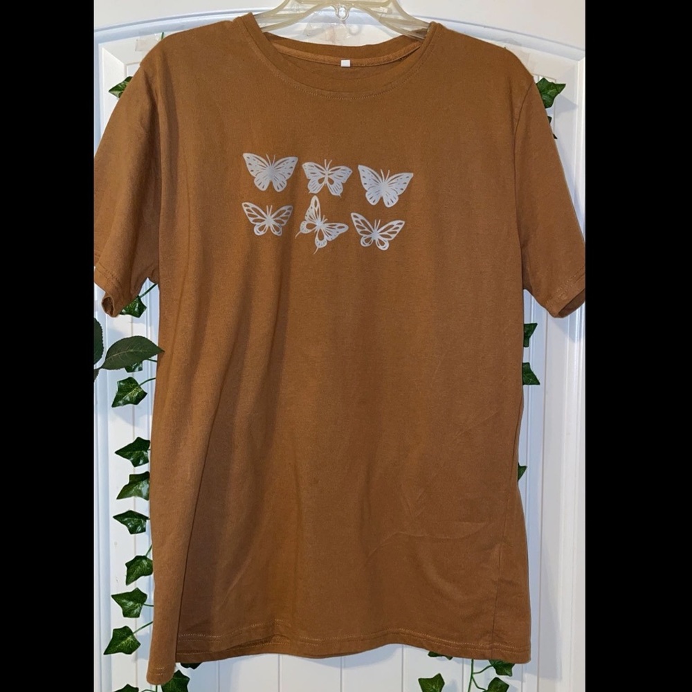 Brown t-shirt with light blue butterflies.